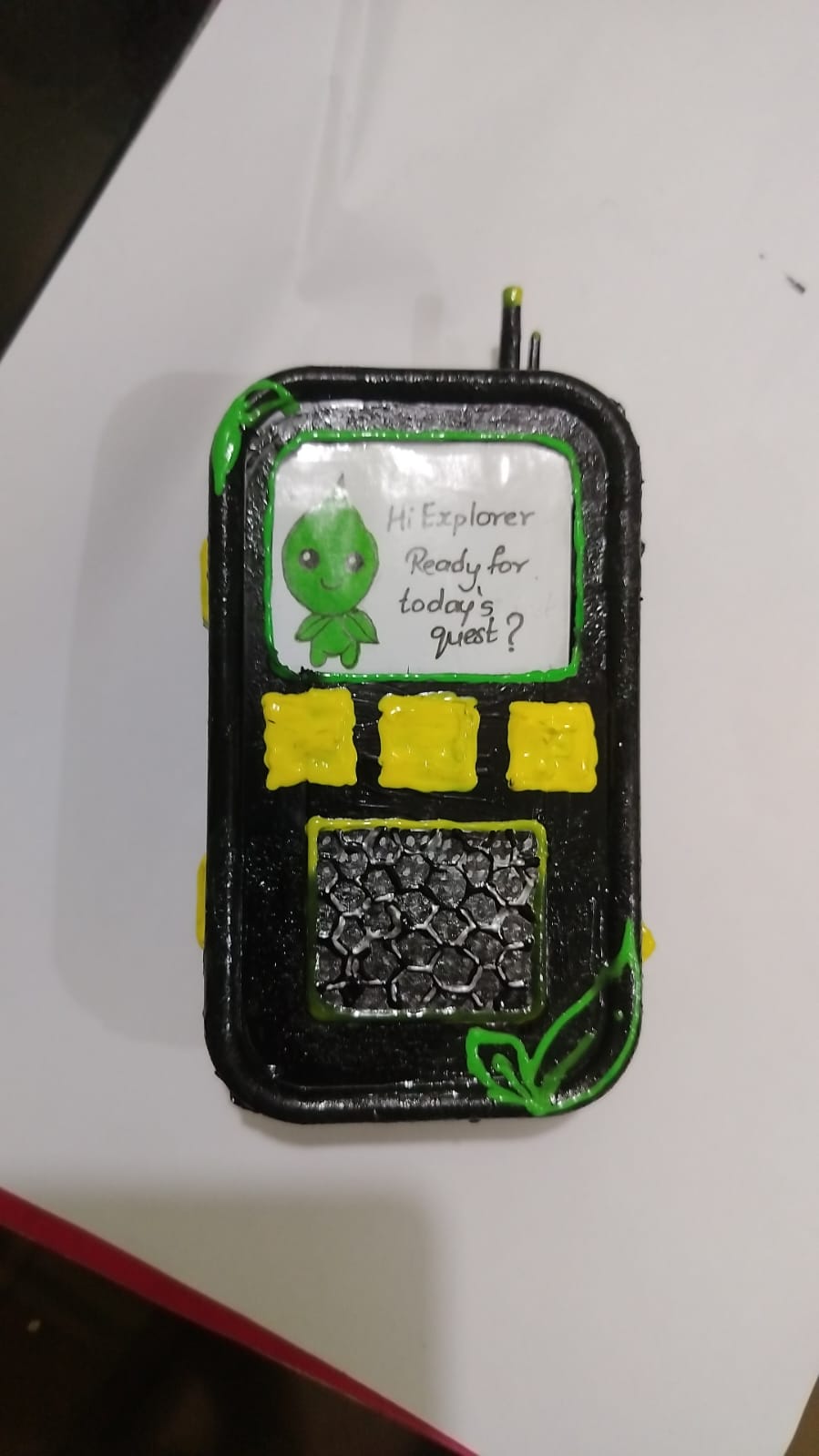 Hand-built painted model of the NatureQuest device showing the mascot asking about today’s quest