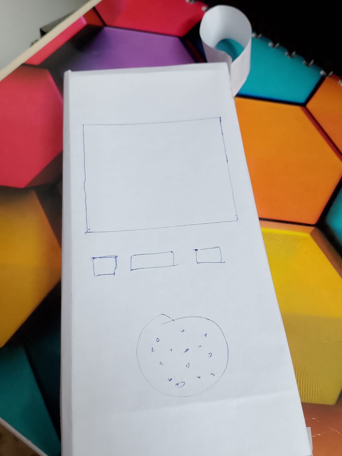 Hand-drawn paper wireframe of the explorer device showing screen, three buttons and speaker grille